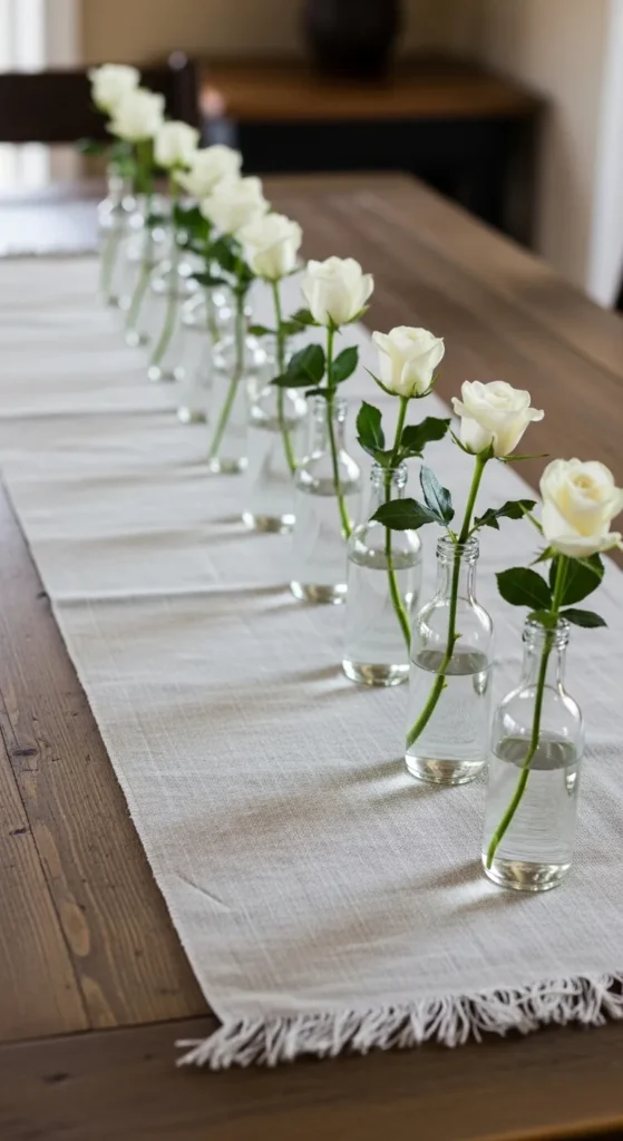 White Roses in Small Glass Bottles